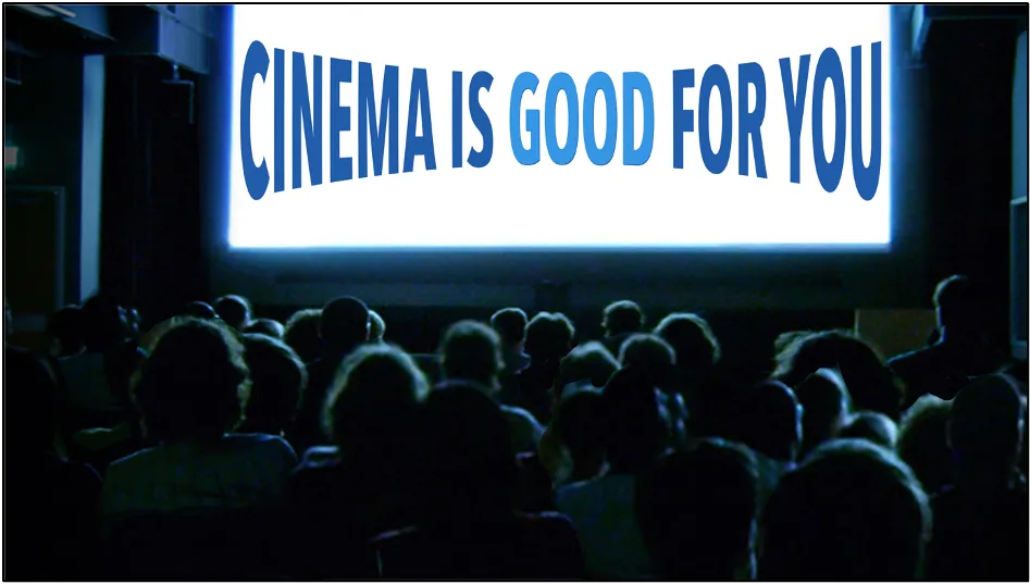 A darkened cinema audience watching a screen that reads “Cinema is good for you”
