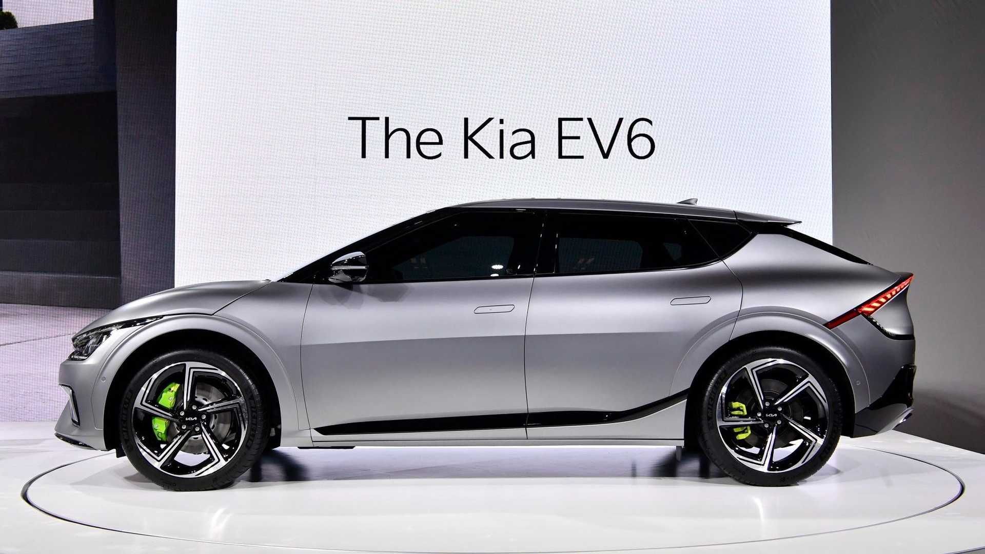 The silver Kia EV6 displayed side-on at a launch event, in front of a screen reading "The Kia EV6"
