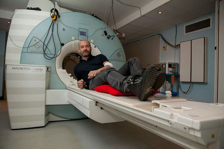 A person lying in an MRI scanner