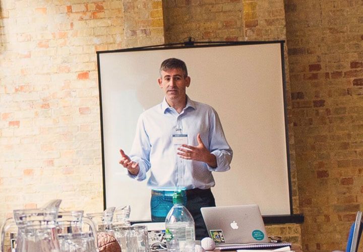 A speaker presenting to an audience