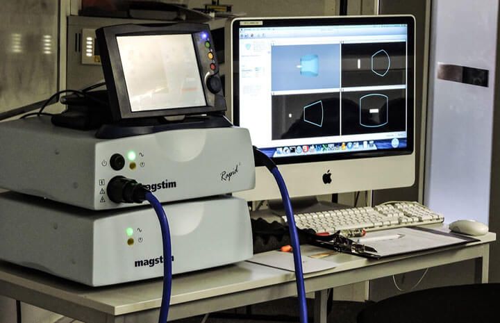 A TMS coil and monitoring screens
