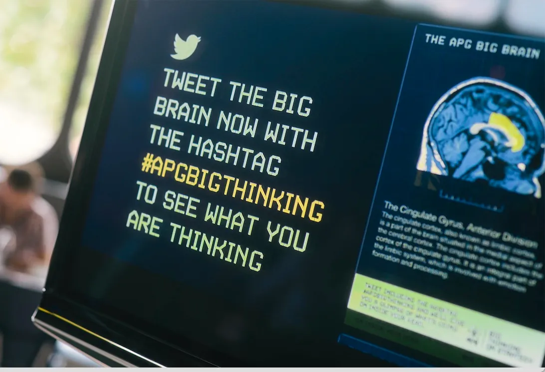 A tweet reply showing a brain-slice image with the relevant region highlighted